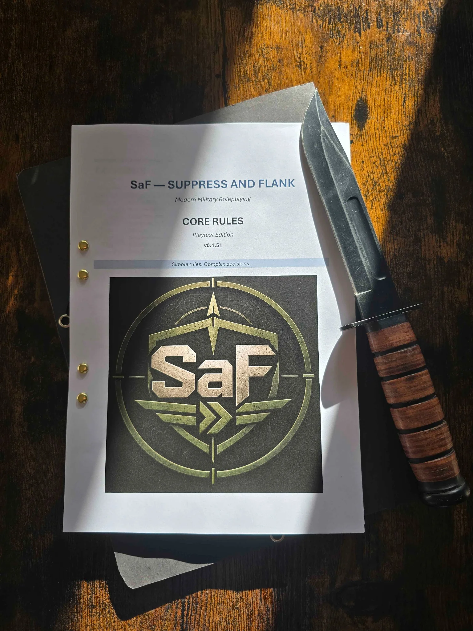 Printed SaF Core Rules playtest copy on a wooden table